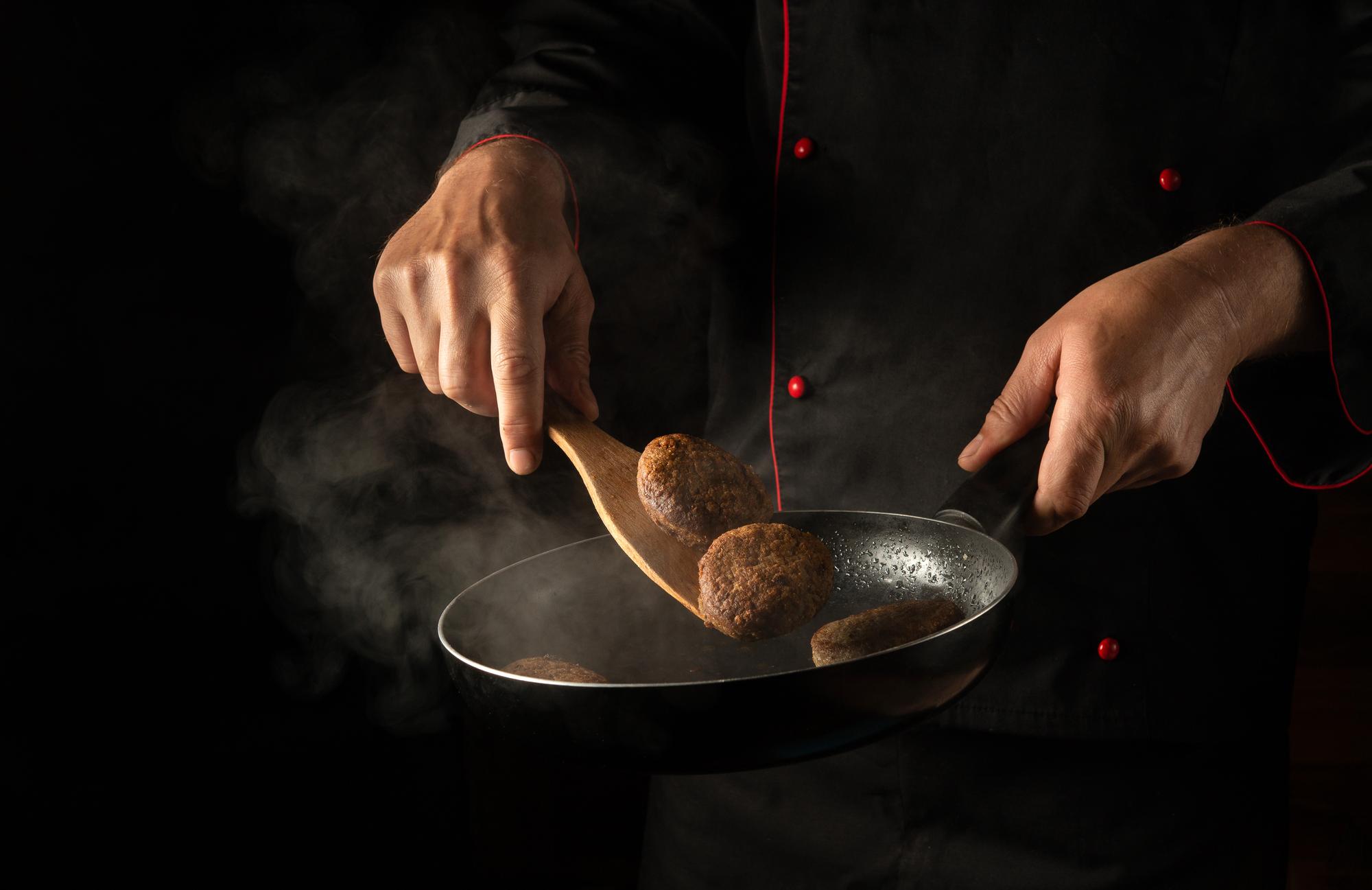 Chef hands plating in studio kitchen